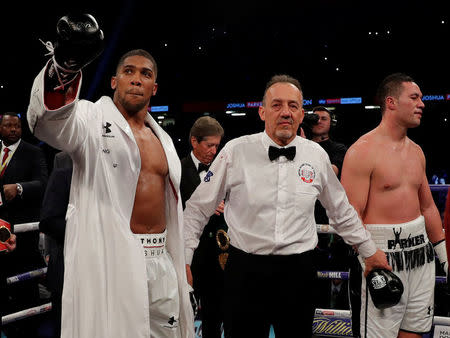 Boxing - Anthony Joshua vs Joseph Parker - World Heavyweight Title Unification Fight - Principality Stadium, Cardiff, Britain - March 31, 2018 Anthony Joshua celebrates after winning the fight as Joseph Parker looks dejected Action Images via Reuters/Andrew Couldridge