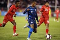 Oct 16, 2018; East Hartford, CT, USA; United States defenseman Reggie Cannon (18) drives the ball against Peru midfielder Edison Flores (20) and defenseman Nilson Loyola (22) in the second half during an international friendly soccer match at Pratt & Whitney Stadium. Mandatory Credit: David Butler II-USA TODAY Sports