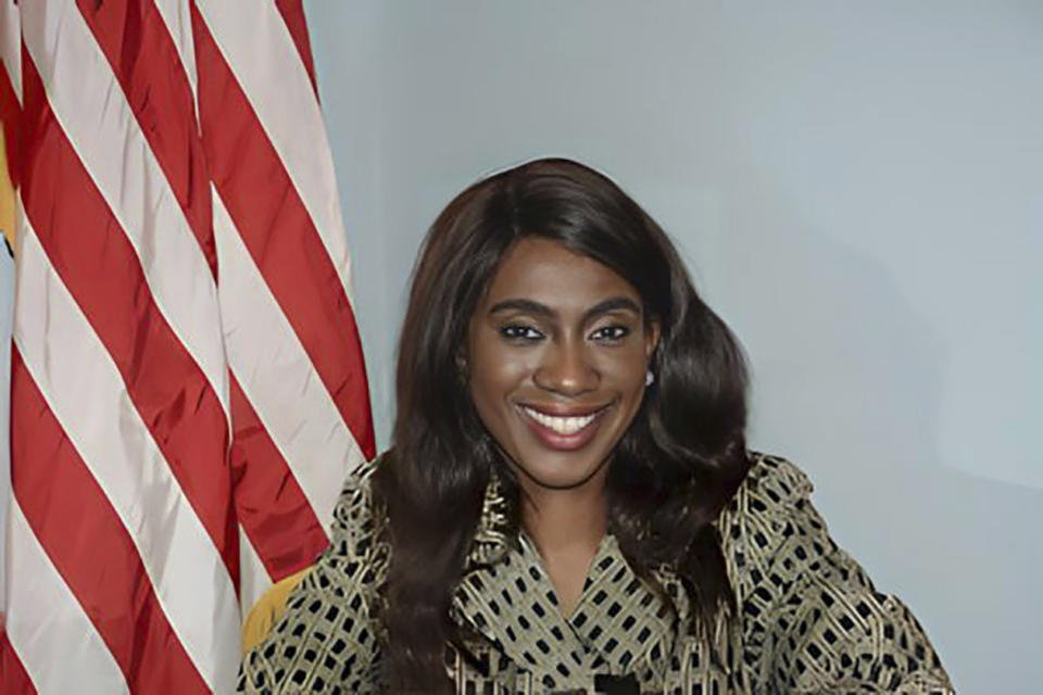 Sayreville, New Jersey, Councilwoman Eunice Dwumfour smiles at the camera while seated in front of an American flag. 