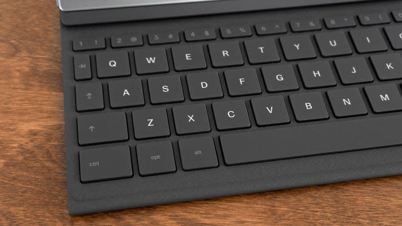 A close-up of the keys on the Type Folio keyboard case sitting on a wooden table.