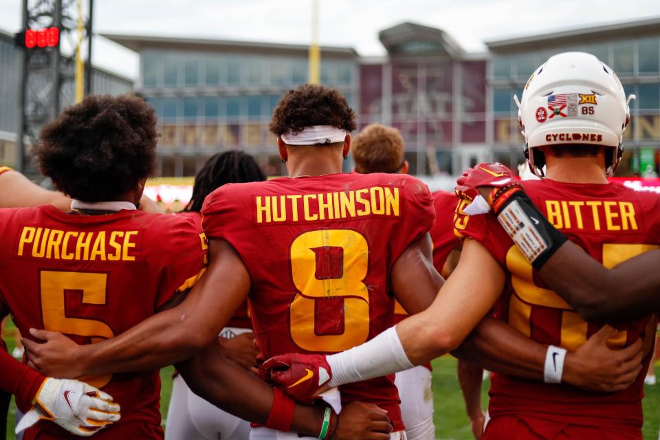 Iowa State players Myles Purchase (5), Xavier Hutchinson (8), and Aidan Bitter (85) sing the Iowa State school song after Saturday's game vs. Ohio at Jack Trice Stadium in Ames.