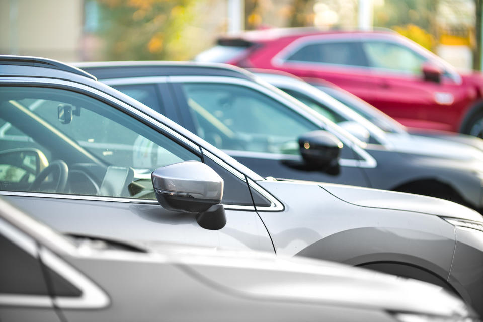 Side shot of a range of used modern vehicles, at a public car dealership