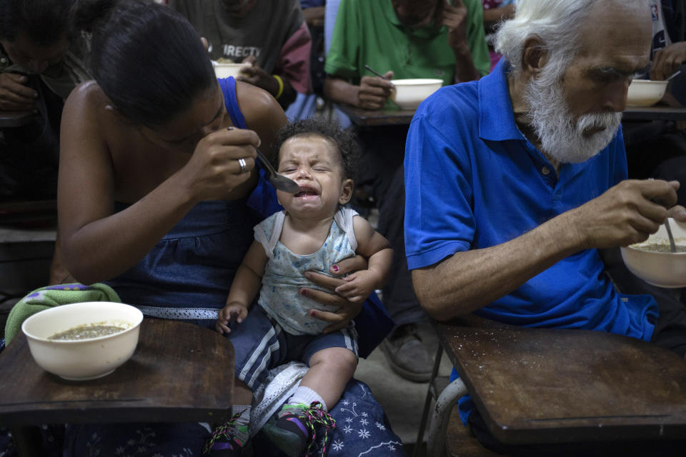 Zoraida Silva, 26, feeds her six month baby Jhon Angel, at a soup kitchen in The Cemetery slum, in Caracas, Venezuela. Silva said that she can not afford to have 3 meals a day, and she has been eating at the soup kitchen for two years ago. According to a survey recently published by the U.N. World Food Program, one of every three Venezuelans cope with food insecurity, unable to get enough food to meet their basic dietary needs. (AP Photo/Ariana Cubillos)