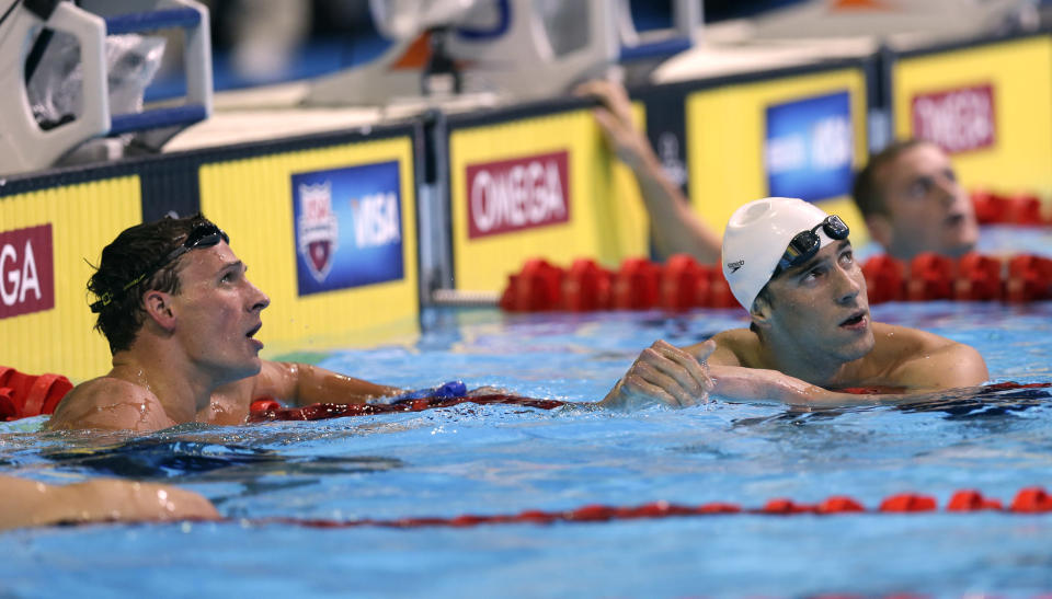 Ryan Lochte, left, and Michael Phelps look at the time after finishing in the men's 400-meter individual medley final at the U.S. Olympic swimming trials, Monday, June 25, 2012, in Omaha, Neb. (AP Photo/David Phillip)