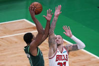 Chicago Bulls center Daniel Theis, right, tries to block Boston Celtics center Tristan Thompson, left, during the first half of an NBA basketball game, Monday, April 19, 2021, in Boston. (AP Photo/Charles Krupa)