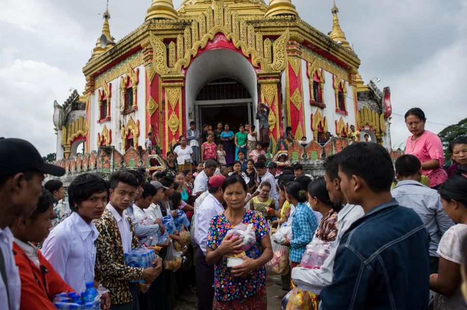 <p>Flood victims receive relief goods at a temple compound in Taungnu township of Bago region in Myanmar on Aug. 31, 2018. (Photo: Ye Aung Thu/AFP/Getty Images) </p>