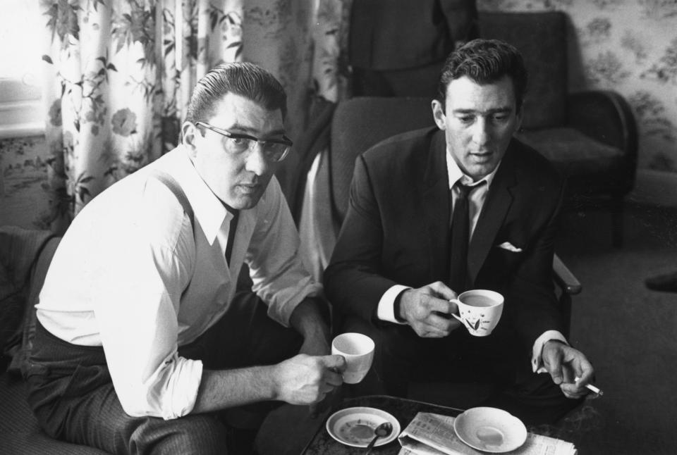 London gangsters Ronnie and Reggie Kray at home having a cup of tea after spending 36 hours being questioned by authorities.