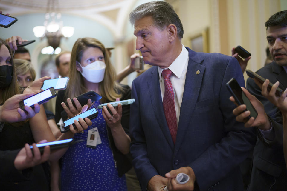 Sen. Joe Manchin, D-W.Va., a key negotiator in the infrastructure talks, is surrounded by reporters as intense negotiations continue to salvage a bipartisan deal, at the Capitol in Washington, Tuesday, July 27, 2021. (AP Photo/J. Scott Applewhite)