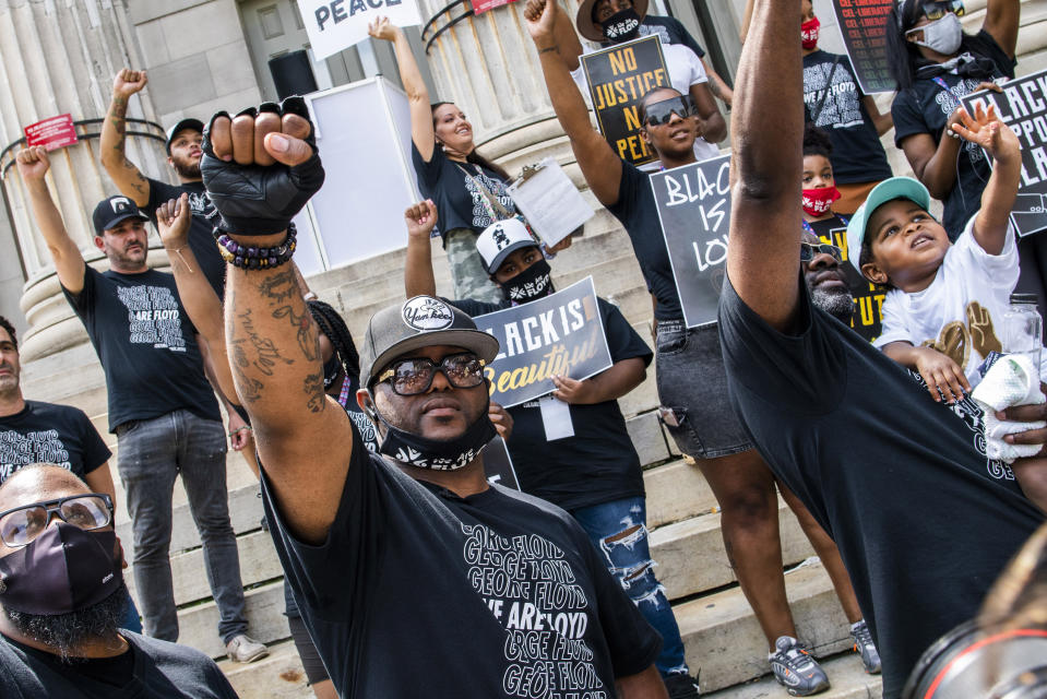 Terrence Floyd, brother of George Floyd, raises his fist with others during a rally on Sunday, May 23, 2021, in Brooklyn borough of New York. George Floyd, whose May 25, 2020 death in Minneapolis was captured on video, plead for air as he was pinned under the knee of former officer Derek Chauvin, who was convicted of murder and manslaughter in April 2021. (AP Photo/Eduardo Munoz Alvarez)