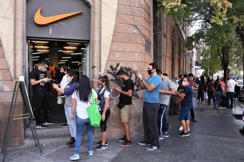 MONTERREY, MEXICO - NOVEMBER 09: People line up to enter the Nike store during "Buen Fin" shopping day on November 9, 2020 in Monterrey, Mexico. (Photo by Medios y Media/Getty Images)