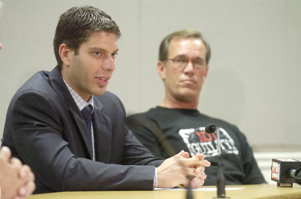 William Dillon listens as assistant public defender Mike Pirolo speaks during a press conference in 2008.