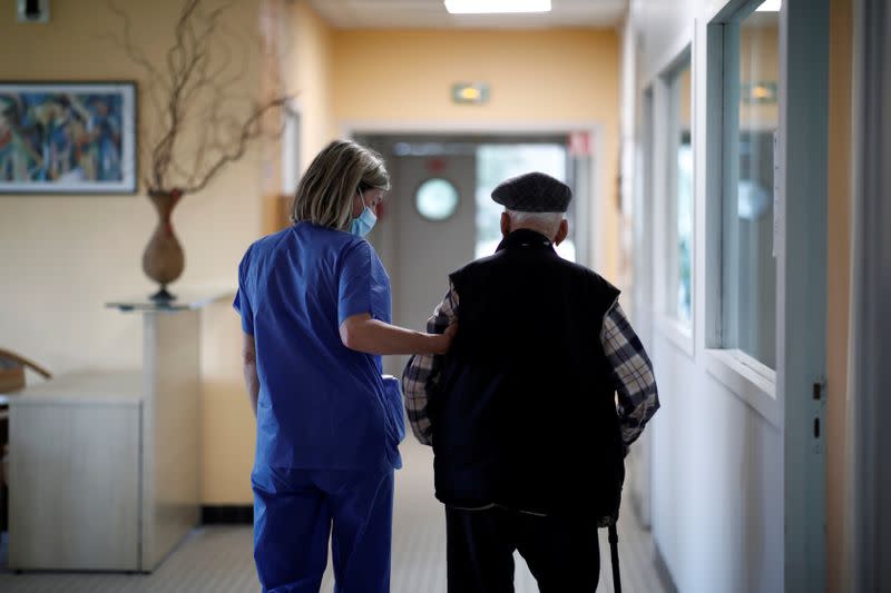 A resident walks with a walking stick at the Emile Gerard retirement home (EHPAD) in Livry-Gargan