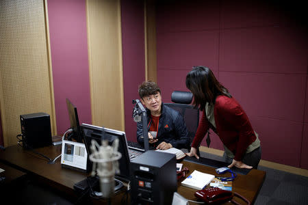 Kim Chung-seong, a North Korean defector and a Christian missionary, talks with a producer before a radio broadcast at a radio station in Seoul, South Korea, April 21, 2016. REUTERS/Kim Hong-Ji