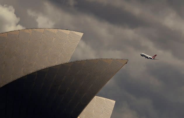 A Qantas A-380 plane flies past the Sydney Opera house in central Sydney, Australia March 11, 2013.