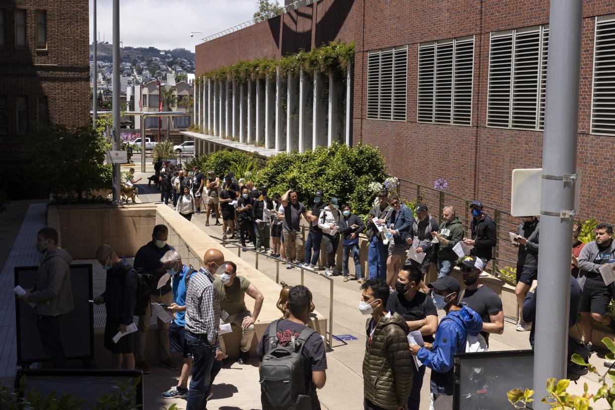 People stand in long lines to receive the monkeypox vaccine at San Francisco General Hospital in San Francisco, July 12, 2022.