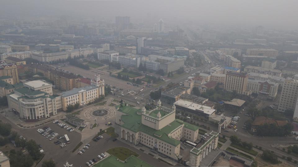 Heavy smoke covers the center of of Ulan-Ude, the regional capital of Buryatia, a region near the Russia-Mongolia border, Russia, Thursday, Aug. 1, 2019. Russian officials say the forest fires blazing in remote areas of Siberia and the Far East that firefighters cannot reach have spread. (AP Photo/Anna Ogorodnik)
