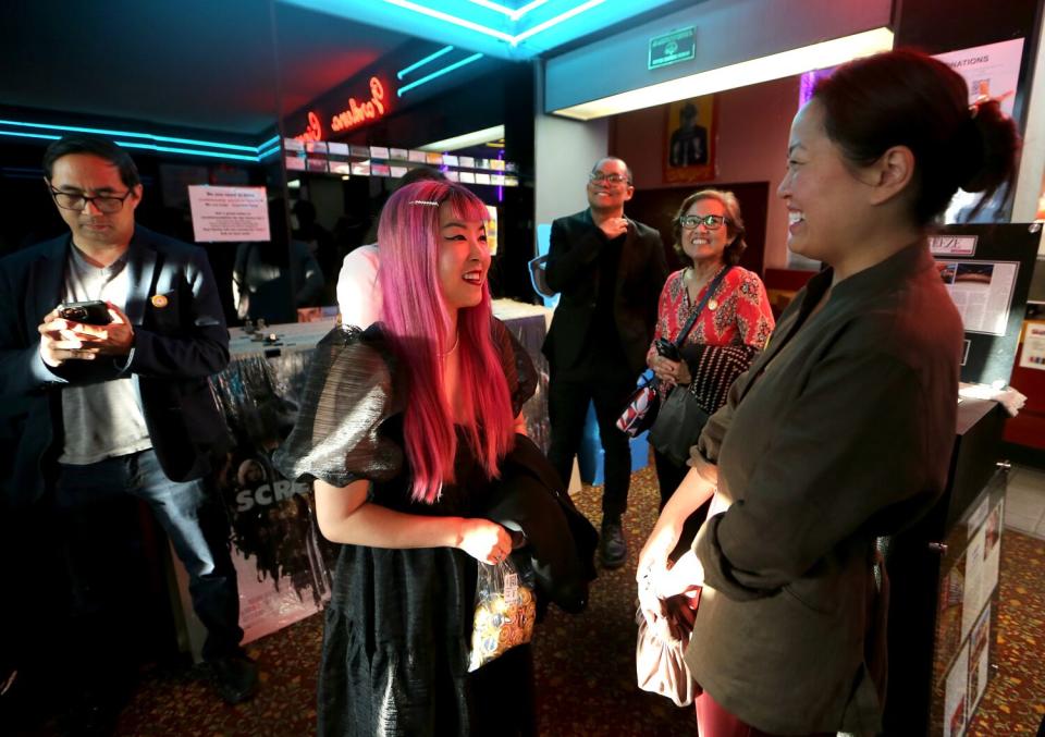 Filmmaker So Yun Um, center, meets with people attending the L.A. premiere of her documentary