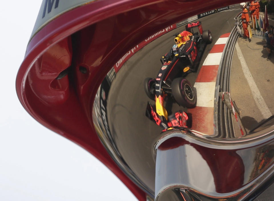 <p>Red Bull driver Daniel Ricciardo of Australia reflected in a helmet of a track marshall while he steers his car during the third free practice at the Monaco racetrack in Monaco, Monaco, May 28, 2016. The Formula one race will be held on Sunday. (AP Photo/Petr David Josek) </p>