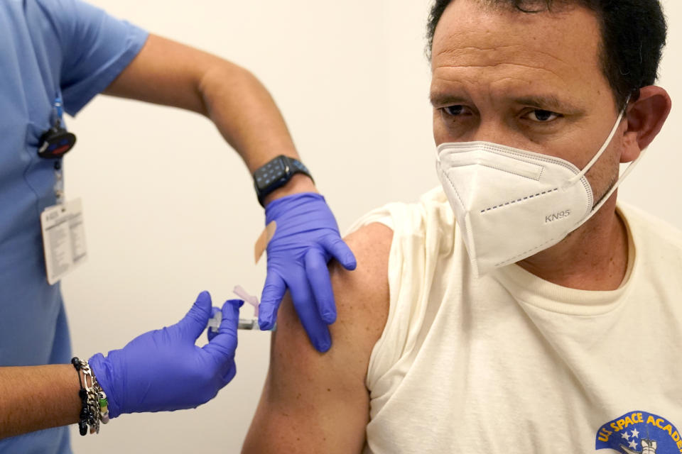 Julio Figuera, 43, receives a vaccine at the Cook County, Ill., medical clinic on Monday, Oct. 16, 2023, in Chicago. "I rarely get sick," he said. "It was the journey that got me sick." Figuera, developed pneumonia since arriving in the U.S. and has been living with hundreds of other asylum seekers at O'Hare International Airport while awaiting more city permanent shelter. When migrants began arriving in Chicago last year, city leaders tapped the county's health system to take over medical care. (AP Photo/Charles Rex Arbogast)