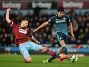 West Ham's Carl Jenkinson (L) challenges Chelsea's Diego Costa during Chelsea's 1-0 win at Upton Park on March 4, 2015