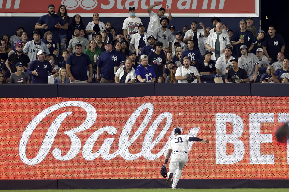 Fans react as New York Yankees left fielder Aaron Hicks (31) can't make the catch on an RBI double hit by Tampa Bay Rays' Randy Arozarena during the fourth inning of a baseball game Friday, Sept. 9, 2022, in New York. (AP Photo/Adam Hunger)