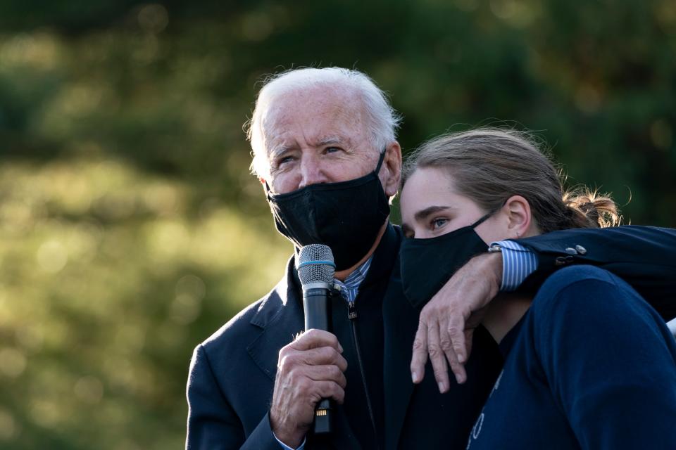 Joe Biden puts his arm around his granddaughter Maisy Biden during a canvass kickoff event on October 31, 2020 in Bloomfield Hills, Michigan.