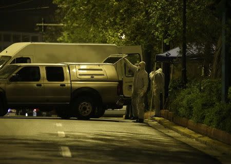 Forensics experts work at the scene after a bomb blast, in central Athens, Greece, April 19, 2017. REUTERS/Alkis Konstantinidis