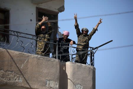 Fighters of Syrian Democratic Forces gesture the "V" sign at the frontline in Raqqa. REUTERS/Rodi Said