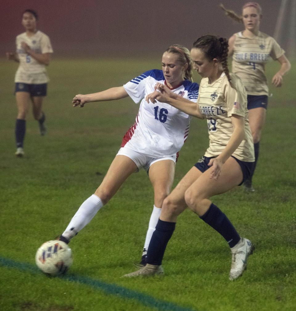 Pace High School's Rebecca Ryan (No. 16) battles Gulf Breeze High School's Lana MacDonald for possession during District 1-6A tournament play on Tuesday, Jan. 31, 2023. 