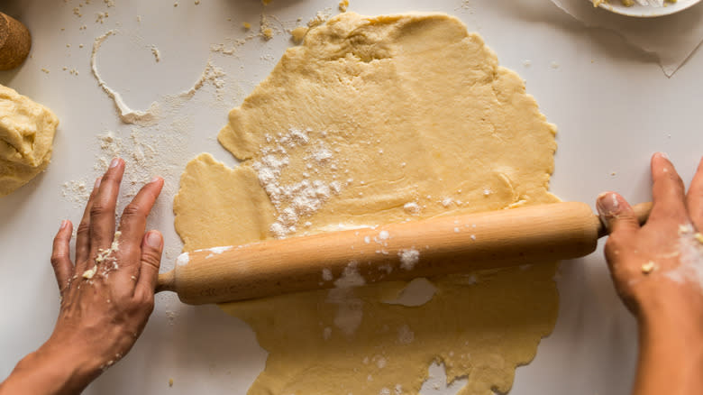 Person rolling out pastry dough