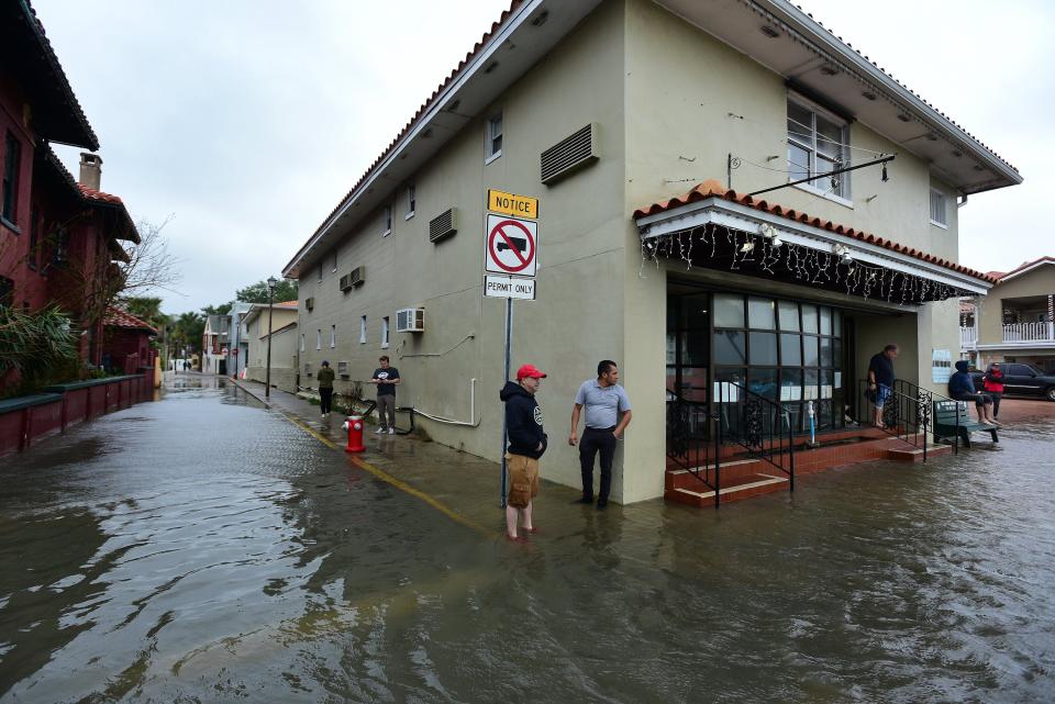 Spectators take in the flooding along Avenida Menendez in St. Augustine's historic district Wednesday ahead of Tropical Storm Nicole's arrival  in Florida adding the potential for new storm surge.