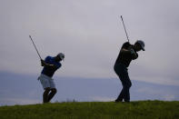 Patrick Cantlay, right, and Gary Woodland chip on the 12th green during a practice round of the U.S. Open Golf Championship, Wednesday, June 16, 2021, at Torrey Pines Golf Course in San Diego. (AP Photo/Jae C. Hong)