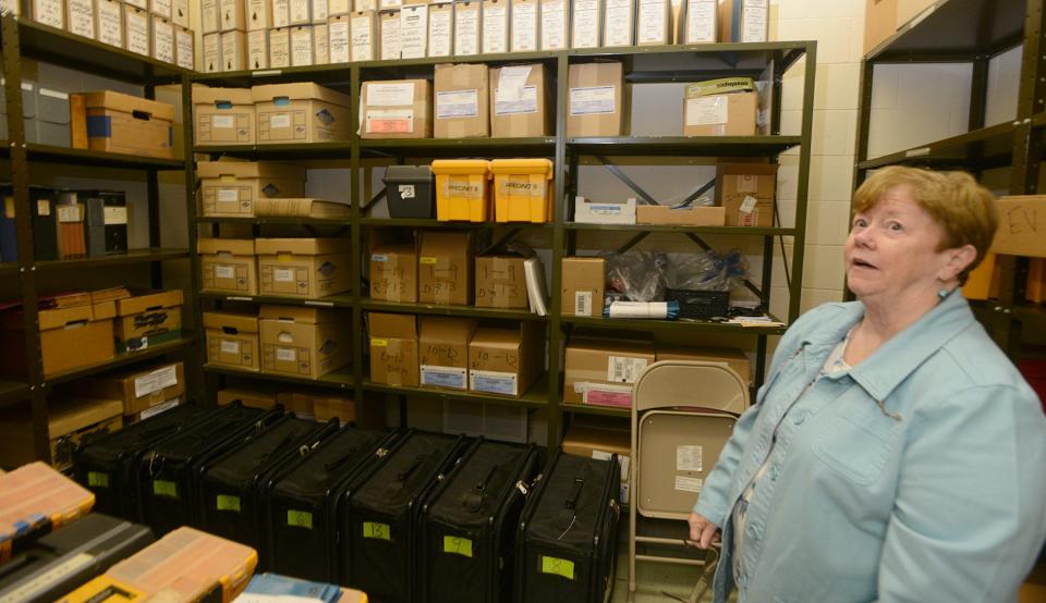 In Hyannis, Town Clerk Ann Quirk inside the vault where precinct voting equipment is stored in the basement at Barnstable Town Hall on Oct. 7. The locking mechanism broke on primary voting day last month and is now undergoing repairs.
