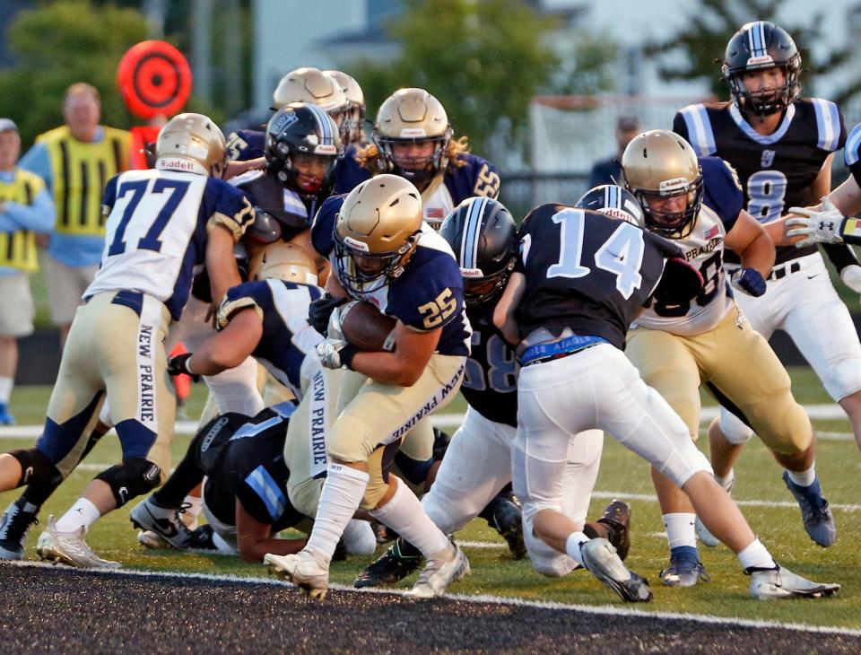 New Prairie senior Brock Sinka (25) scores the first touchdown of the game for the Cougars against South Bend Saint Joseph Friday, Sept. 15, 2023, at Father Bly Field in South Bend.