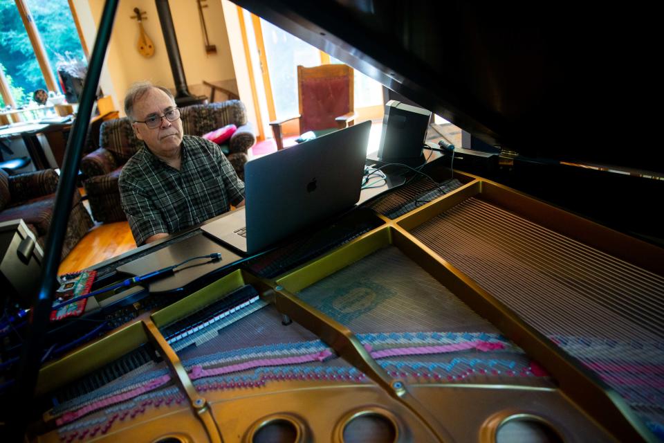 Holland composer Daniel Fisher plays his piano in his home studio Wednesday, July 20, 2022. Fisher's album "Places Far Away" took six years to produce and debuted at #3 on the Billboard classical charts. 