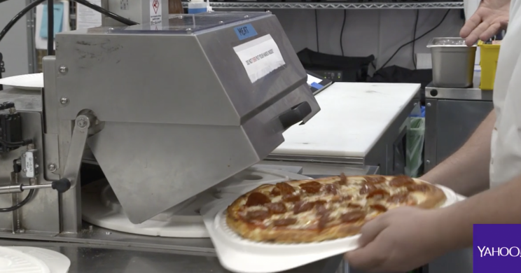 In half a second, this machine cuts the 14-inch pizza into 8 slices.