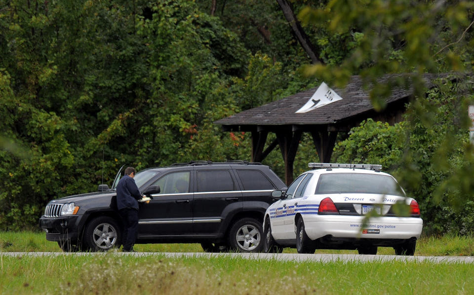 A Detroit Police officer is seen near a late model black Jeep, Thursday Sept. 20, 2012, on Belle IslePark following a suicide by a suspect wanted in connection for a fatal stabbing at the Jefferson Chrysler plant on Jefferson in Detroit. An employee fatally stabbed a co-worker Thursday at a Chrysler factory and then fled to the park where he killed himself, police said. (AP Photo/The Detroit News, Steve Perez) DETROIT FREE PRESS OUT; HUFFINGTON POST OUT. MANDATORY CREDIT