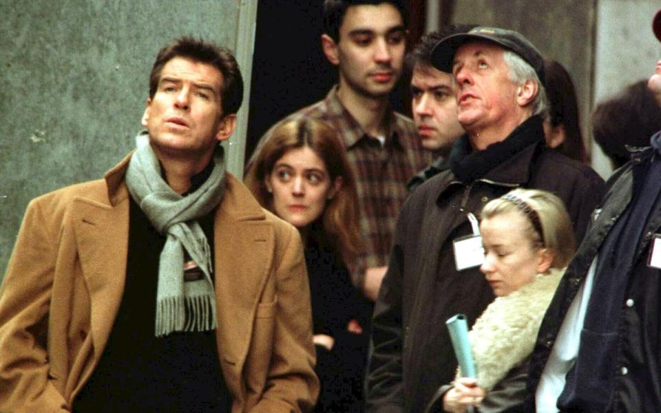 Apted with Pierce Brosnan in 1999 as they filmed The World Is Not Enough - EPA