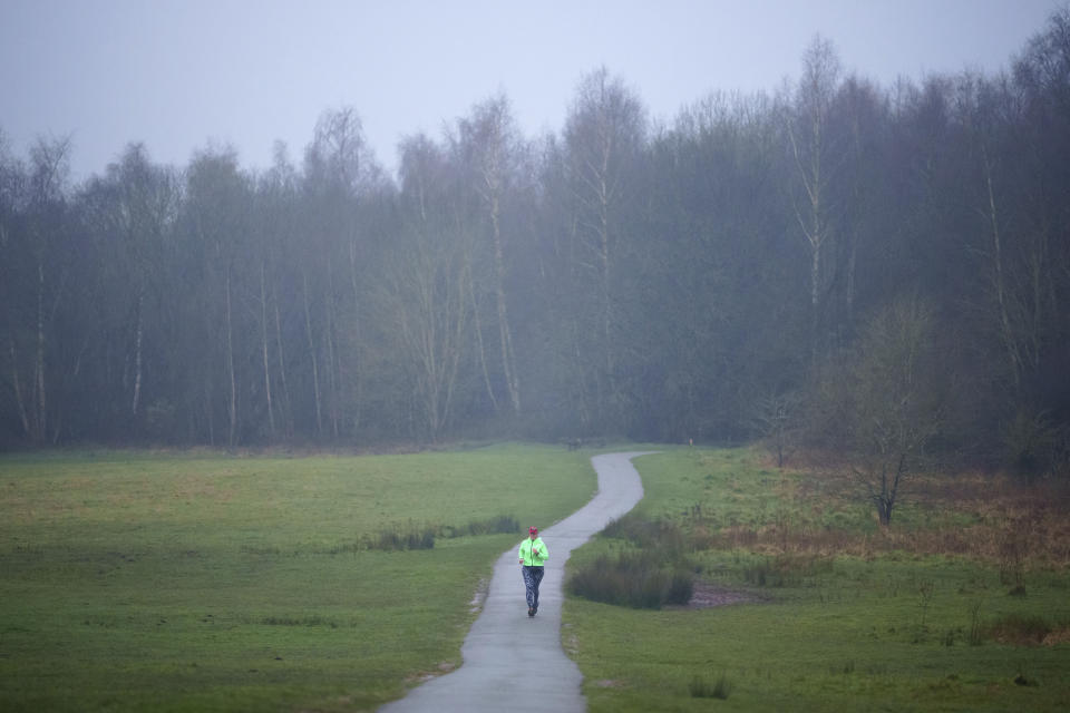 Ultra runner Helen Ryvar passes through Alyn Waters Country Park in Wrexham during running a half marathon in Wrexham, Wales, Wednesday, March 20, 2024. Helen who took up running in 2020 just before lockdown completes her daily half marathon early so as to fit in a full time job and being a single parent to 3 children. (AP Photo/Jon Super)