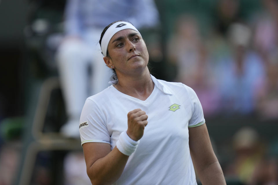 Tunisia's Ons Jabeur celebrates defeating China's Bai Zhuoxuan during the women's singles match on day five of the Wimbledon tennis championships in London, Friday, July 7, 2023. (AP Photo/Alastair Grant)