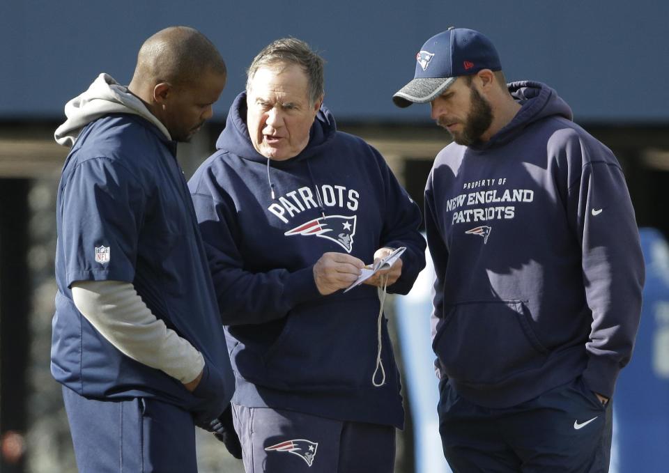 Patriots linebackers coach Brian Flores, left, speaking with head coach Bill Belichick, center, and defensive line coach Brendan Daly, is well versed in the Patriot Way from top to bottom. (AP) 