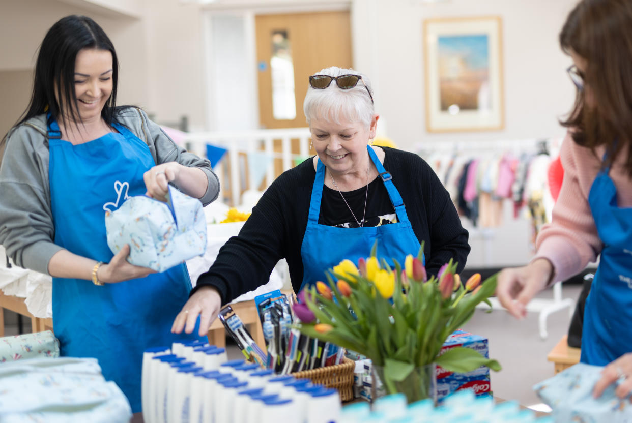 Lottery winners (L-R) Katy Canty, Christine Howlett and Tracy Field help pack washbags at Baby Basics Lowestoft. (National Lottery/ PA)