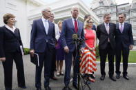 President Joe Biden, with a bipartisan group of senators, speaks Thursday June 24, 2021, outside the White House in Washington. Biden invited members of the group of 21 Republican and Democratic senators to discuss the infrastructure plan. From left are, Sen. Jeanne Shaheen, D-N.H., Sen. Rob Portman, R-Ohio, Sen. Bill Cassidy, R-La., Sen. Lisa Murkowski, R-Alaska, Biden, Sen, Joe Manchin, D-W.Va., rear, Sen. Kyrsten Sinema, D-Ariz, Sen. Mark Warner, D-Va., and Sen. Mitt Romney, R-Utah. (AP Photo/Jacquelyn Martin)