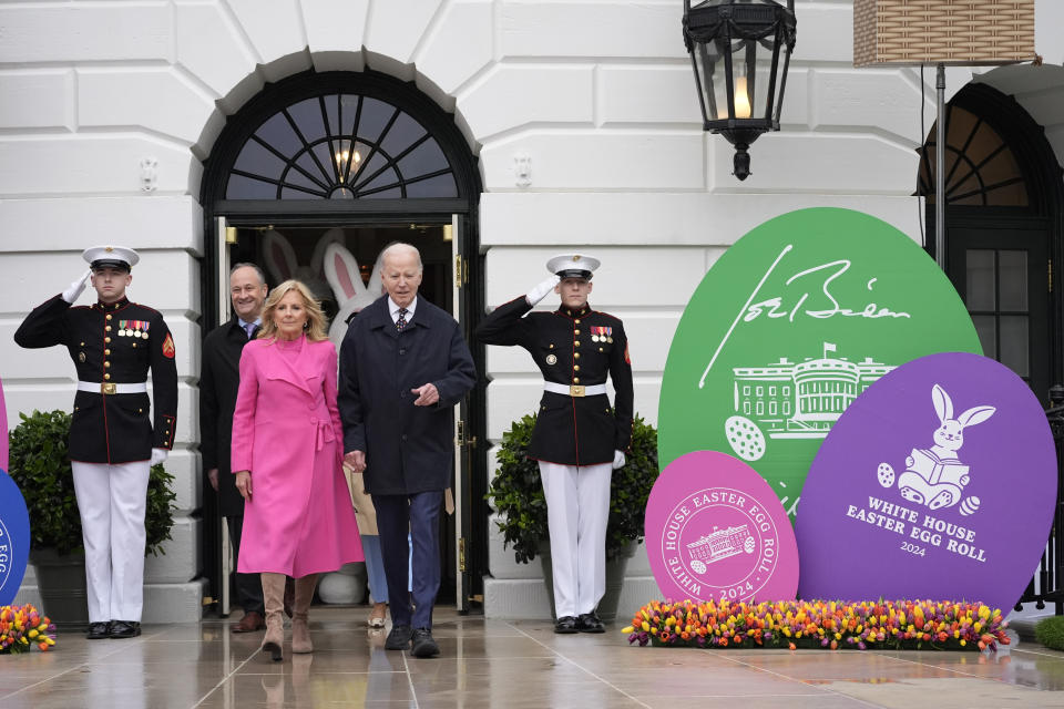 FILE - President Joe Biden, center right, and first lady Jill Biden, center left, arrive at the White House Easter Egg Roll on the South Lawn of the White House, Monday, April 1, 2024, in Washington. On Friday, April 5, The Associated Press reported on stories circulating online incorrectly claiming Biden banned religious symbols from a White House Easter egg art contest. (AP Photo/Evan Vucci, File)