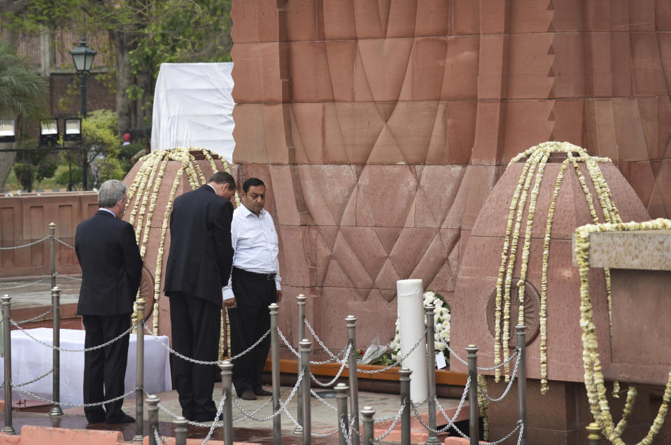 British High Commissioner to India Dominic Asquith, second left, pays homage to commemorate century of the Jallianwala Bagh incident, in Amritsar, India, Saturday, April 13, 2019. On April 13, 1919, hundreds were killed and more than 1,200 injured after British troops led by Reginald Dyer opened fire on a peaceful gathering at Jallianwala Bagh in Amritsar. (AP Photo/Prabhjot Gill)