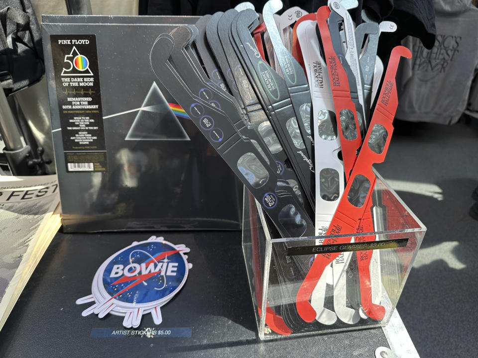 Eclipse glasses are for sale along with Pink Floyd's "Dark Side of the Moon," album at the Rock Roll Hall of Fame in Cleveland, Sunday, April 7, 2024. (AP Photo/Stephanie Nano)
