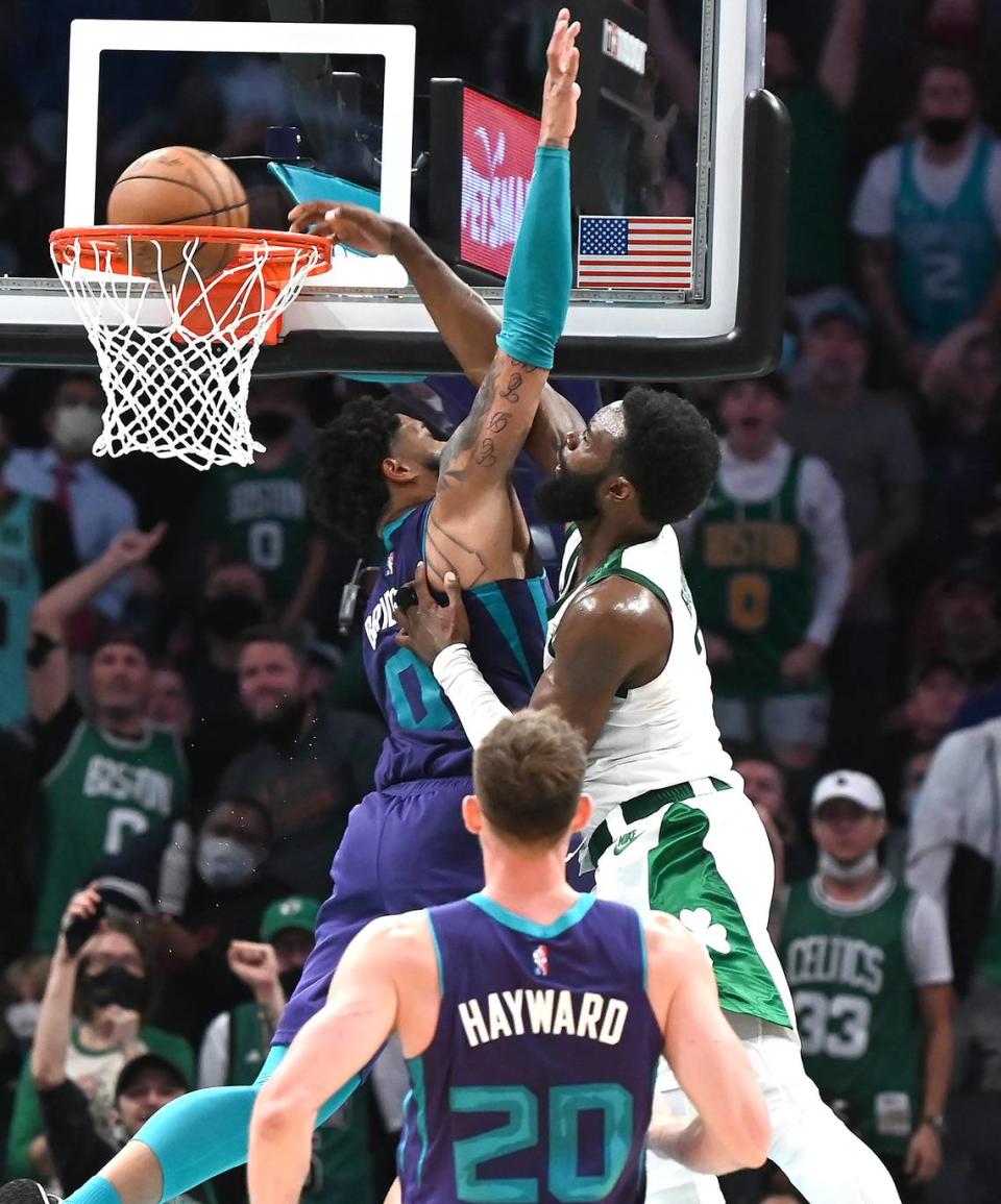 Boston Celtics wing Jaylen Brown, right, throws down a one-handed dunk over Charlotte Hornets forward Miles Bridges at the Spectrum Center Monday. The Celtics defeated the Hornets 140-129 in overtime, and Brown had 30 points.