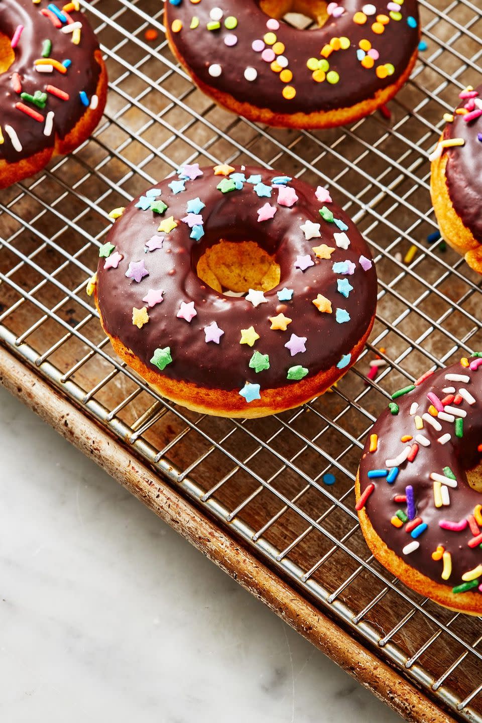 <p>These baked donuts are just as satisfying as the fried version, but <em>so</em> much lighter. We can't resist a good chocolate glaze, but these would also be delicious rolled in cinnamon sugar, <a href="https://www.delish.com/cooking/recipe-ideas/a27117110/easy-churros-recipe/" rel="nofollow noopener" target="_blank" data-ylk="slk:churro;elm:context_link;itc:0;sec:content-canvas" class="link ">churro</a>-style.<br><br>Get the <strong><a href="https://www.delish.com/cooking/recipe-ideas/a28848608/baked-donuts-recipe/" rel="nofollow noopener" target="_blank" data-ylk="slk:Baked Donuts recipe;elm:context_link;itc:0;sec:content-canvas" class="link ">Baked Donuts recipe</a></strong>.</p>