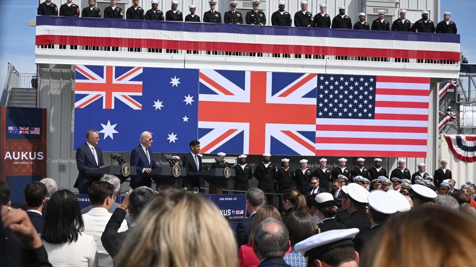 On the podium, from left, Australian Prime Minister Anthony Albanese, U.S. President Joe Biden and British Prime Minister Rishi Sunak hold a news conference after a meeting during the AUKUS summit on March 13, 2023, in San Diego, Calif. (Leon Neal/Getty Images)