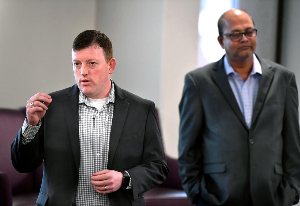 Ryan Goodwin, a candidate for Abilene mayor, makes a point about the Abilene Public Library as one of his opponents, Dasi Reddy, stands behind him.